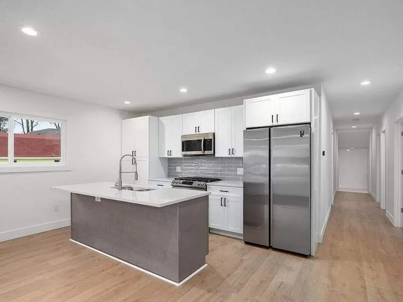 New light vinyl plank flooring in a remodeled West Michigan kitchen